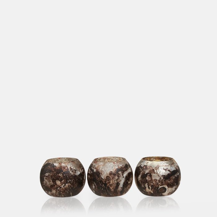 Cutout of the Opa Set of 3 Tealight Holders, a trio of small round glass votives with a frosted swirled white and brown finish