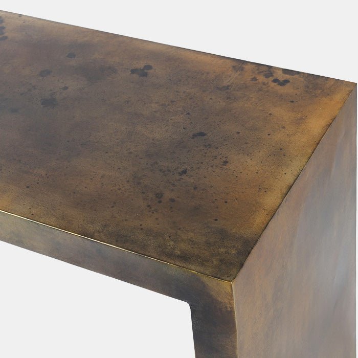 A closeup of the angular corner and burnished gold antique looking metal finish on the Orland Iron Console Table.