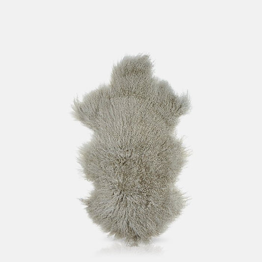 Cutout image on a white background of a pale grey sheepskin
