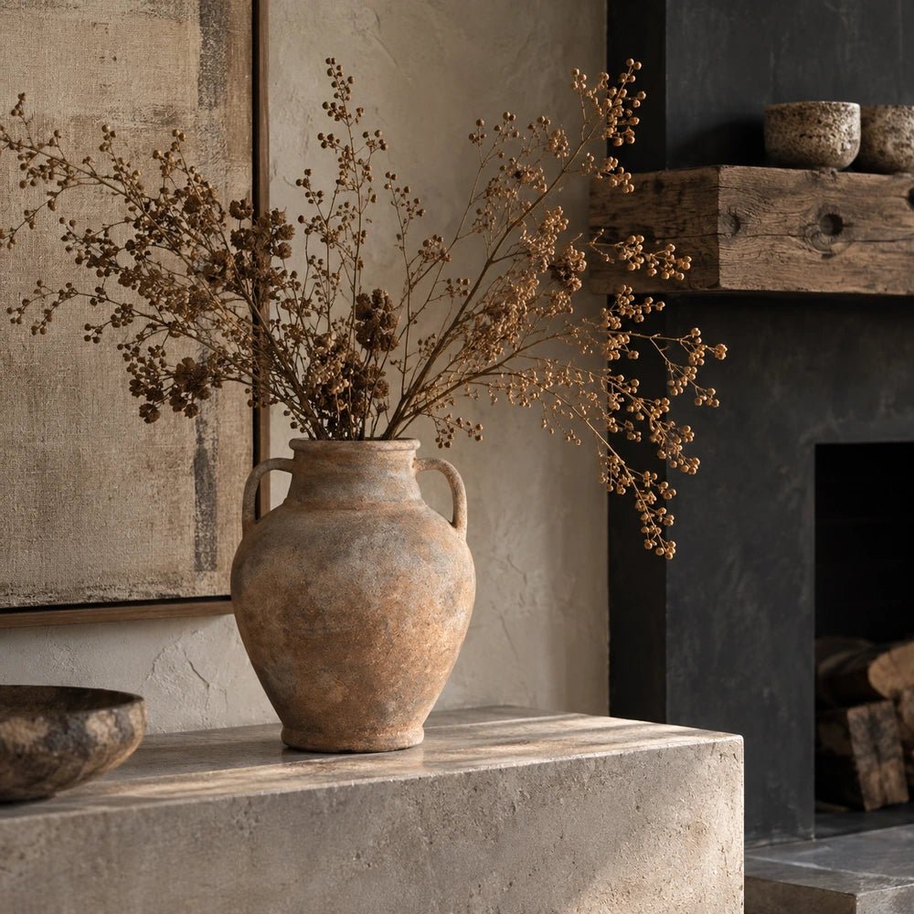 Romeo Vase displayed in a styled console setting with warm neutral accessories, sculptural objects and layered contemporary textures surrounding the decorative vase.