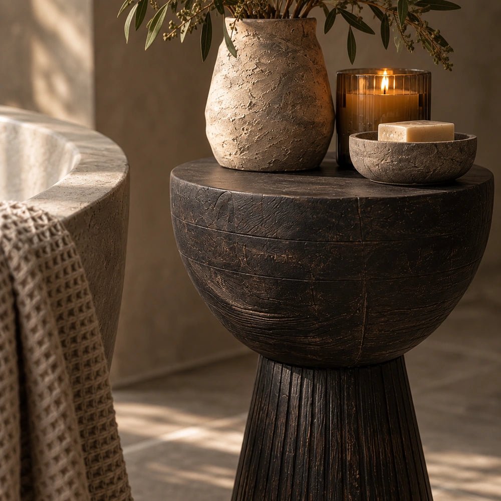 Ronan Black Side Table shown in a styled living room with neutral seating, sculptural accessories and warm layered textures for contemporary interiors.