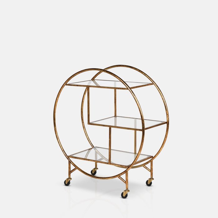 The Rover Drinks Trolley, a three tiered glass drinks trolley on wheels with a round golden frame and a retro look.