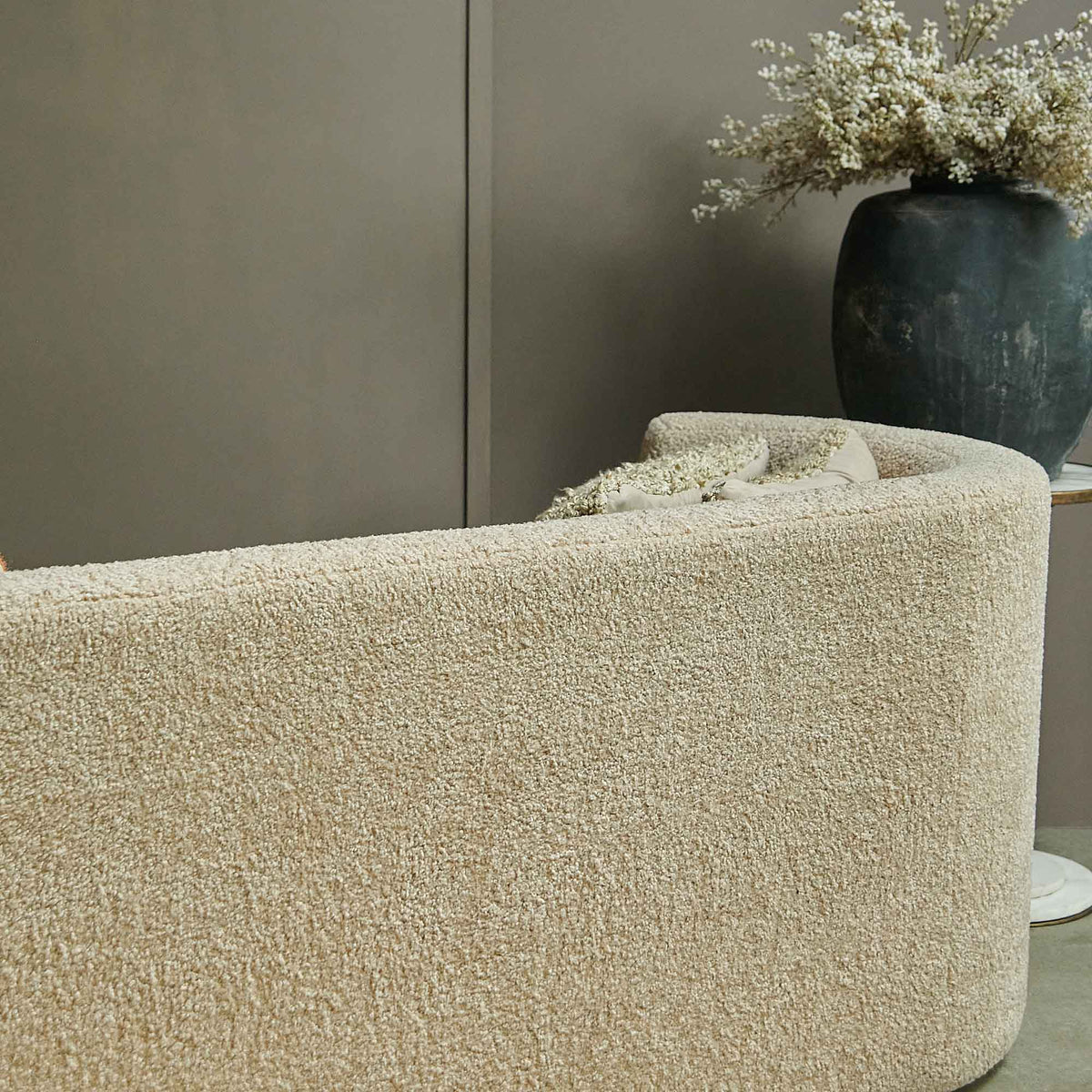 Samara sofa cream boucle upholstery closeup curved two seater modern luxury furniture detail