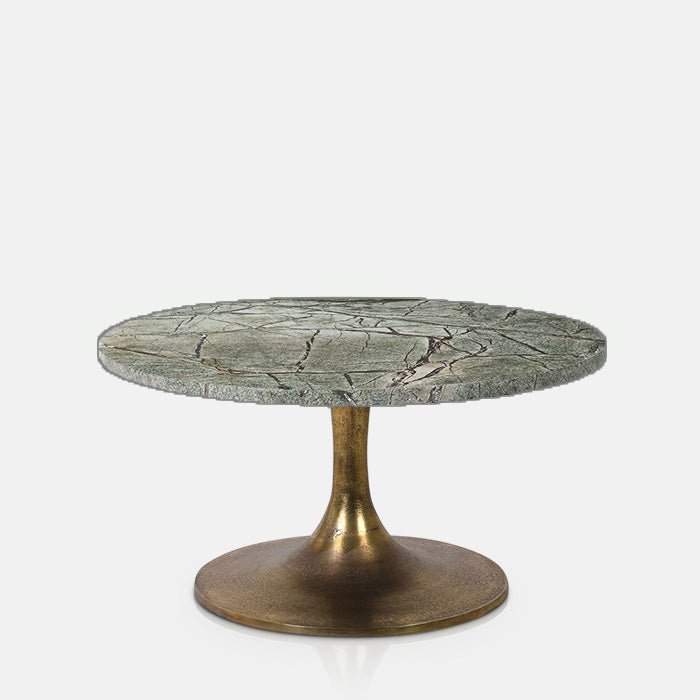 Green marble round coffee table with a natural ssurface, unique veining details and elegant antique gold iron pedestal base. Teller Green Marble Coffee Table by Abigail Ahern, designed as a luxury statement centrepiece for modern living rooms and contemporary interiors. A designer marble coffee table perfect for styling with decorative accessories, books and vases, adding glamour, texture and timeless sophistication to your home decor.