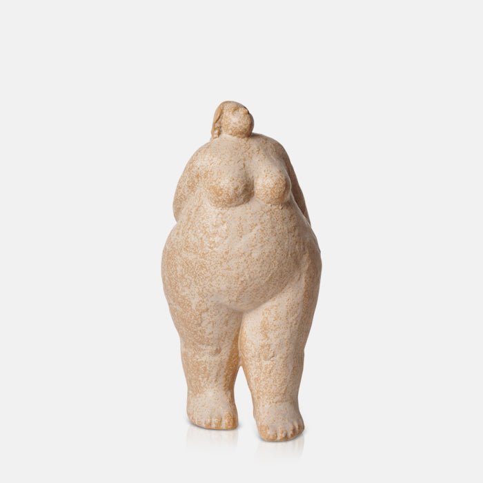 Light coloured standing female sculpture with her hands behind her back. Tall figurative female for an arty look in your home.