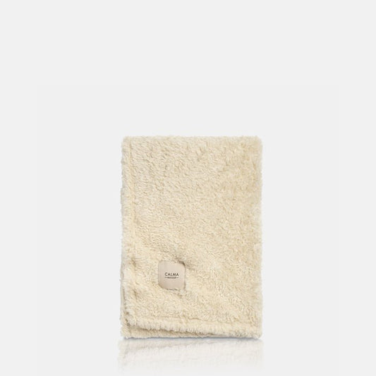 A cutout of a cream folded faux fur throw. Shop now from Abigail Ahern, in homes since 2003.