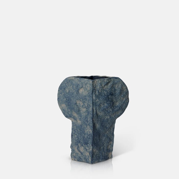 A cutout of the Yilan vase which is a dark coloured vase in an organic shape. Perfect for artificial trailing stems or faux flowers.
