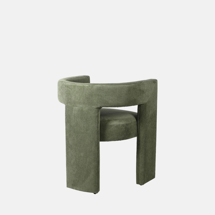 Back view of green armchair with cut out detail.