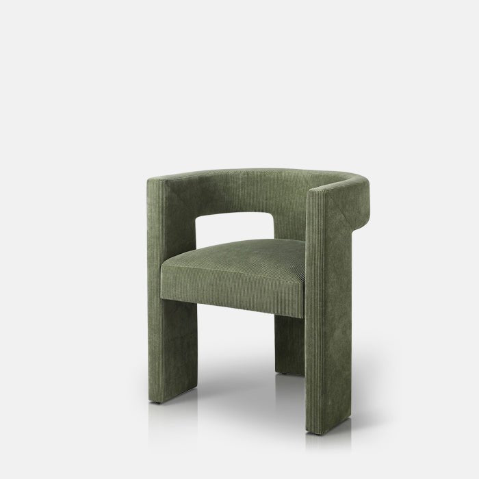 A contemporary green armchair with a cut-out form.