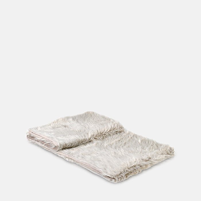 A cutout picture of a folded light grey throw that will add a soft warmth to your home decor.