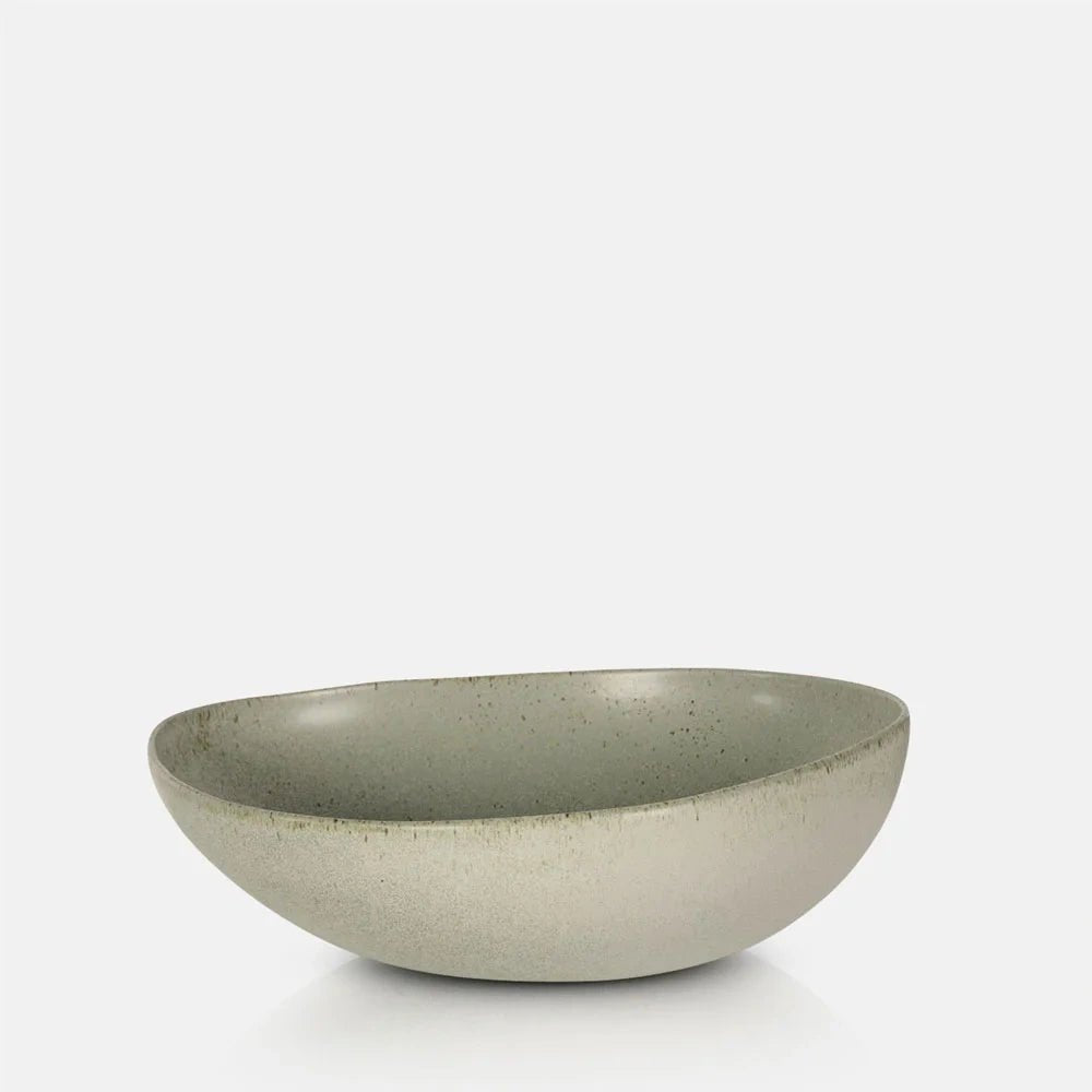Alcott Serving Bowl with a broad rounded shape, pale green interior, beige exterior and fine speckled finish, shown from an angled front view.