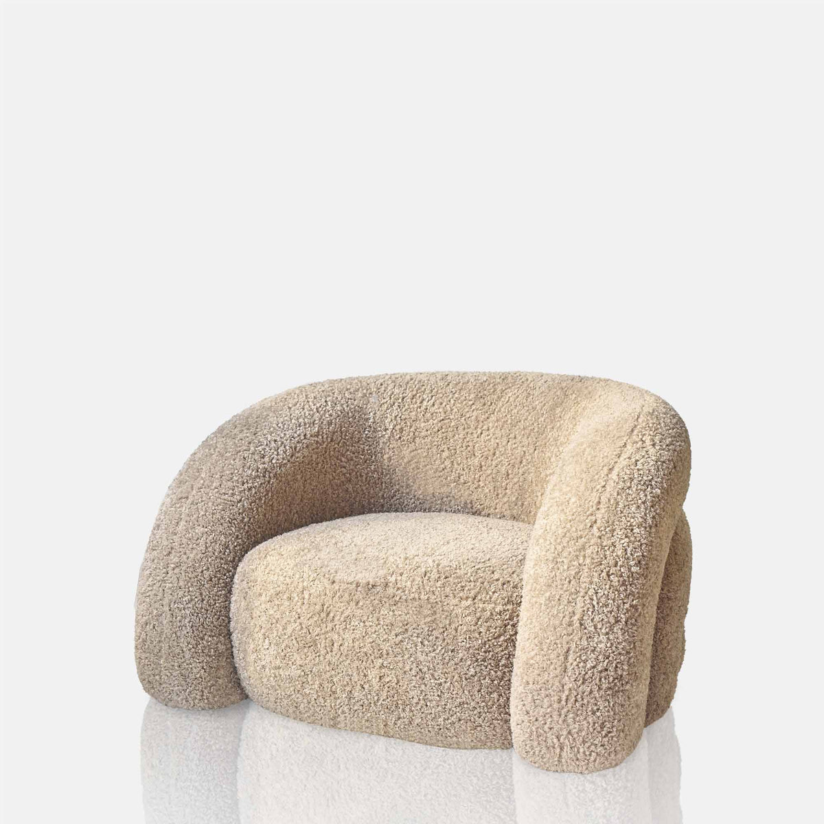 Neutral curved armchair with a plush upholstered finish, rounded silhouette and deep comfortable cushioning. Almar Curved Armchair by Abigail Ahern, designed with a warm earthy tone and contemporary shape to create a stylish statement seating piece. A luxury accent chair perfect for living rooms, bedrooms and cosy reading spaces, adding texture, comfort and timeless elegance to modern home interiors.