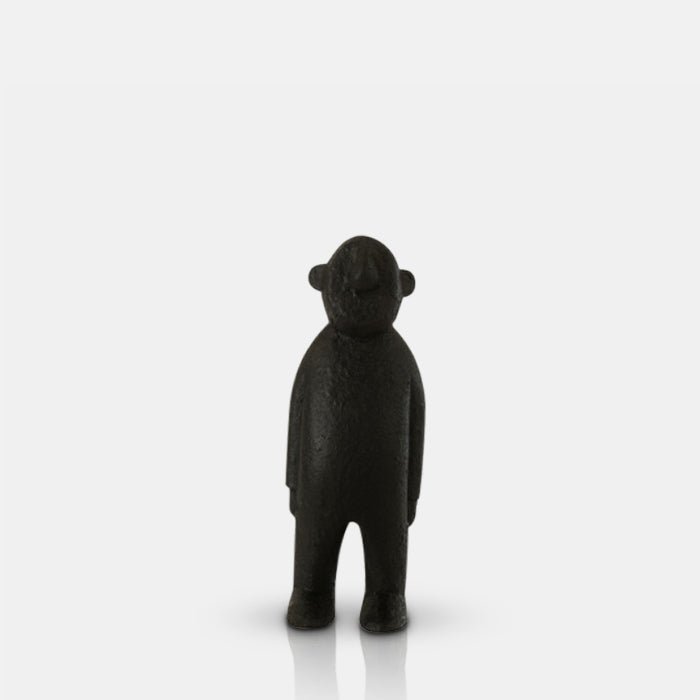 A cutout of the Amethi Wooden Sculpture, a small figurative sculpture in black wood.