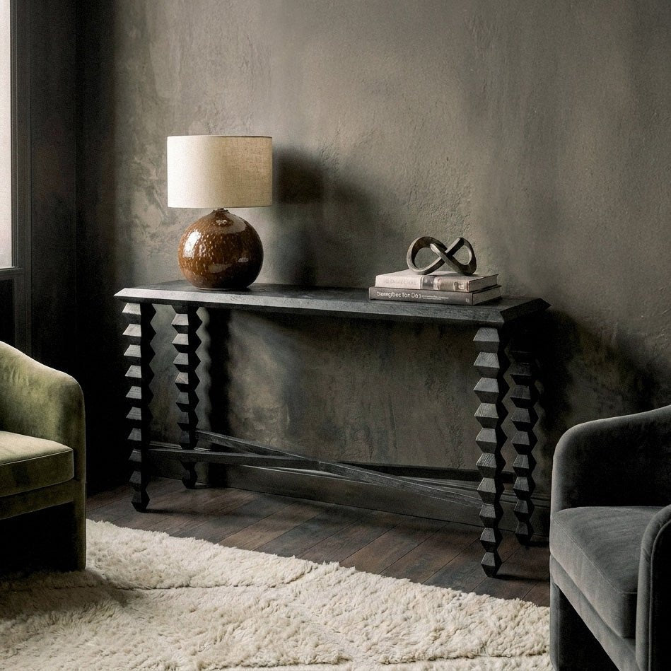 Abigail Ahern Antrim Wooden Console Table crafted from warm-toned mango wood with a slim black frame, styled with decorative accessories to showcase its long, elegant silhouette.