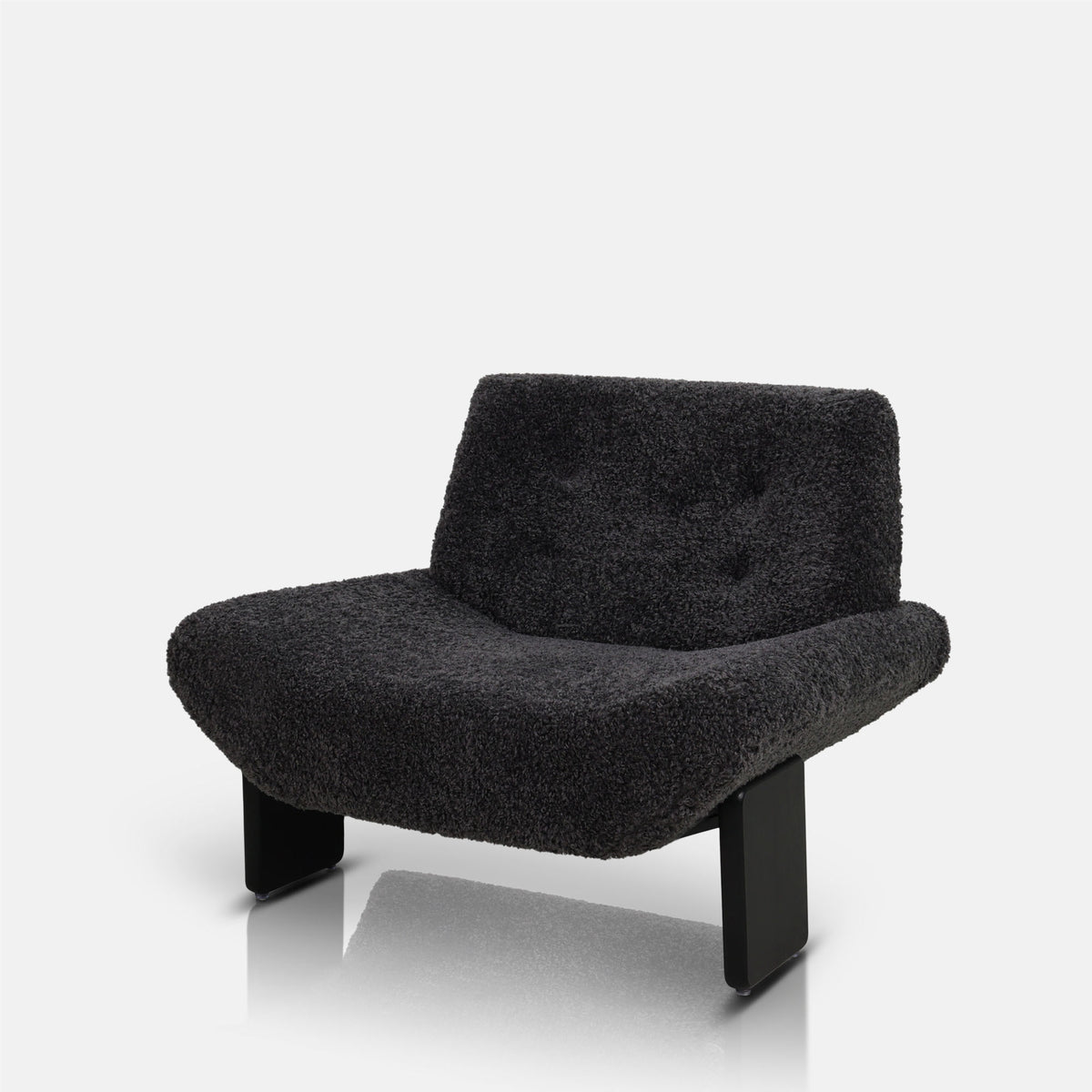 Cut out image of the Abigail Ahern Axel Faux Shearling Accent Chair in rich charcoal grey, featuring a distinctive modern silhouette with softly curved lines and plush, tactile upholstery. A statement accent chair that adds warmth, texture and personality to modern, eclectic interiors, ideal for a sitting room, bedroom or stylish home office.
