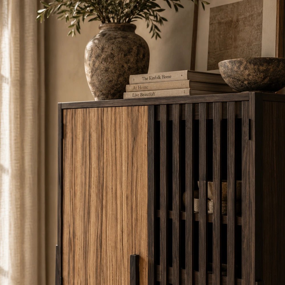 Batten Wooden Cabinet styled with a table lamp and decorative accessories in a warm neutral room, highlighting its natural wood grain and storage.