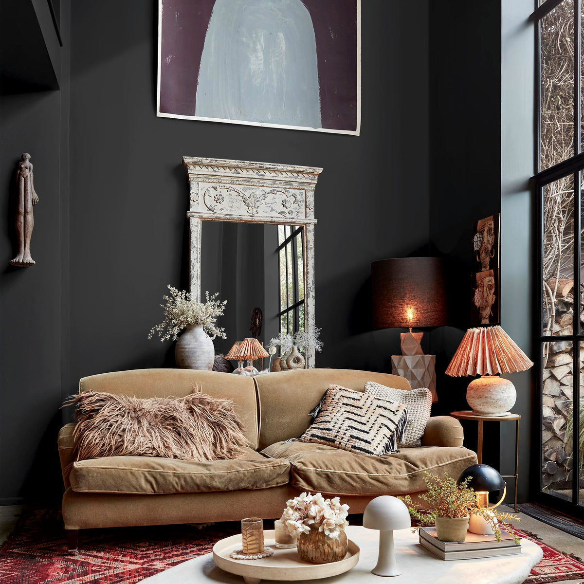 An eclectic and textural living room painted in an anthracite grey paint colour.