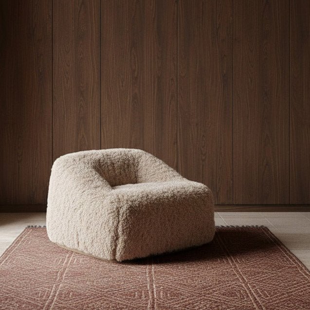 Abigail Ahern Bertha Faux Fur Armchair in a soft neutral hue, featuring an oversized rounded silhouette with plush faux fur upholstery, styled as a cosy statement chair in a warm contemporary interior.