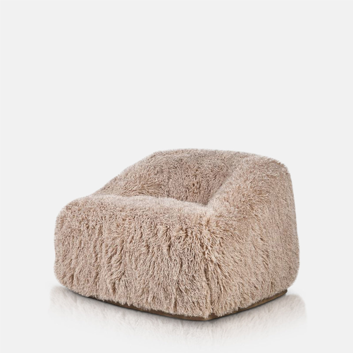 Abigail Ahern Bertha Faux Fur Armchair with a generously oversized seat, low rounded back and sumptuous textured faux fur upholstery, creating a soft and inviting focal point for a modern living space.
