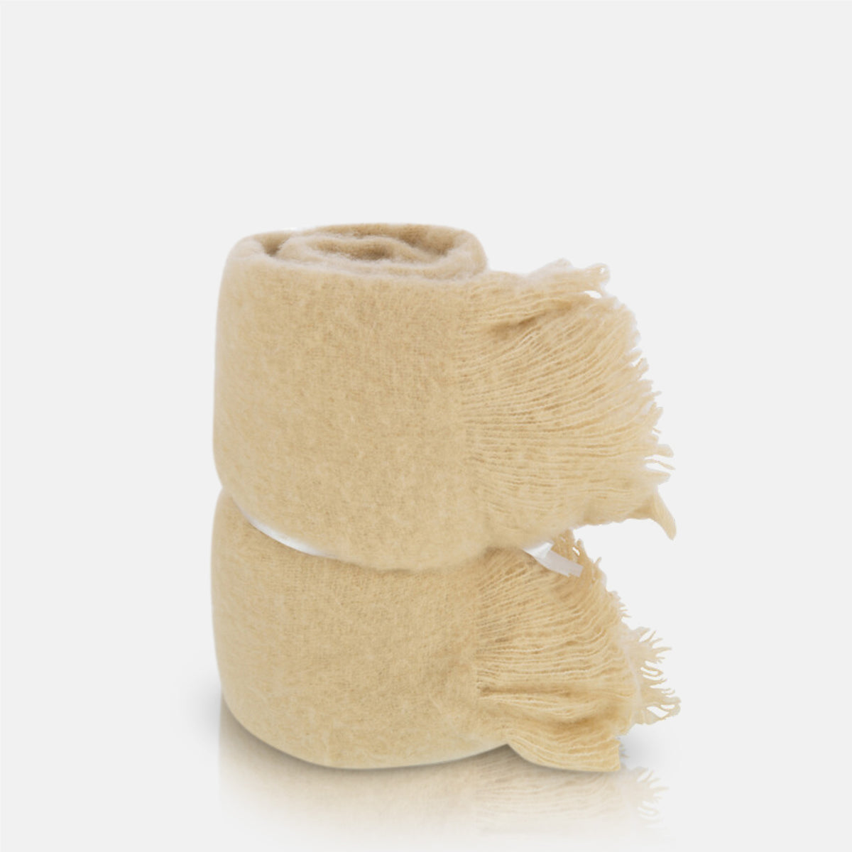 A cutout of the Borough Beige Throw, a soft cream coloured throw with fringed ends.