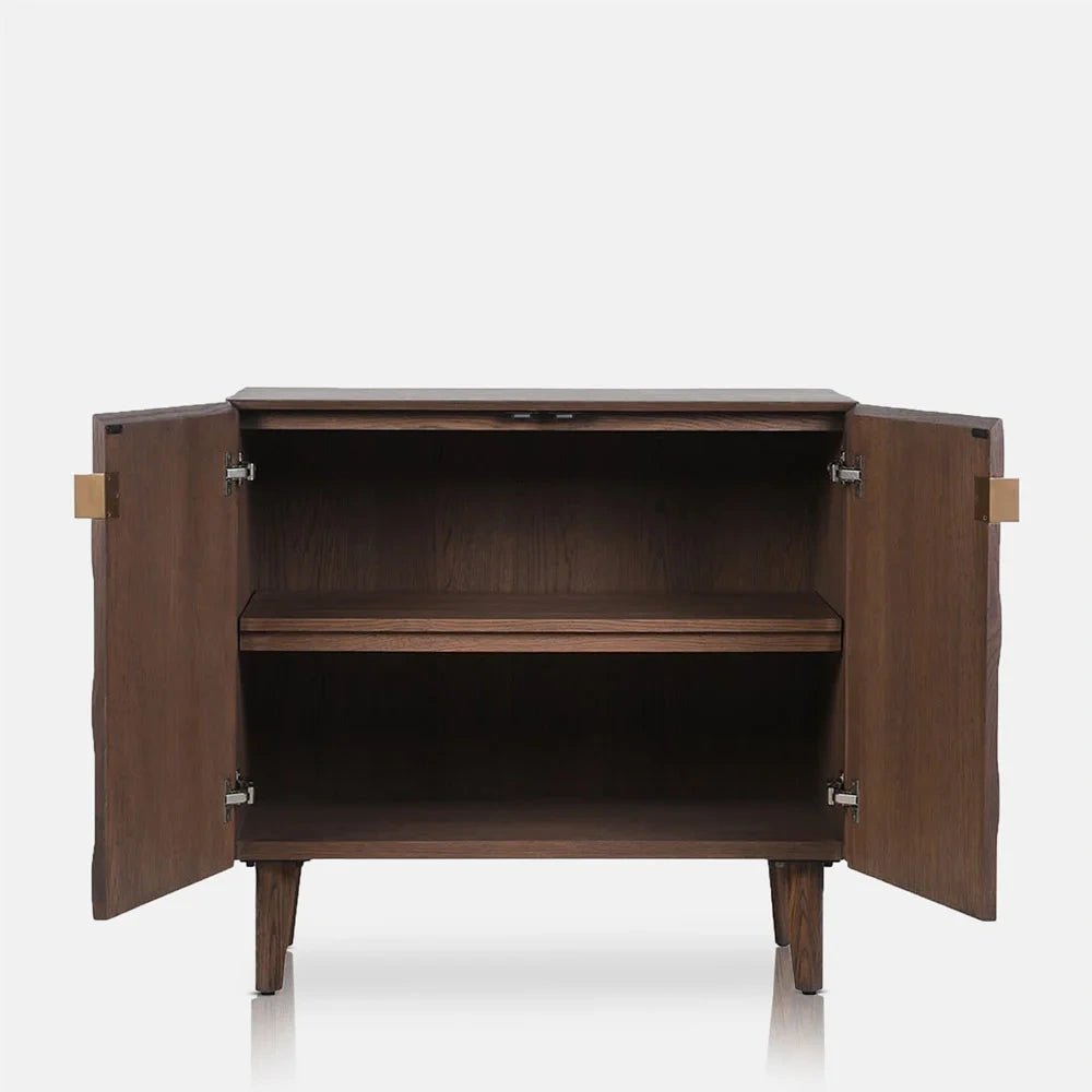 Bradley Wooden Cabinet with both doors open, revealing dark interior shelving, a warm brown wooden exterior, brass coloured hinges and four slim tapered legs.
