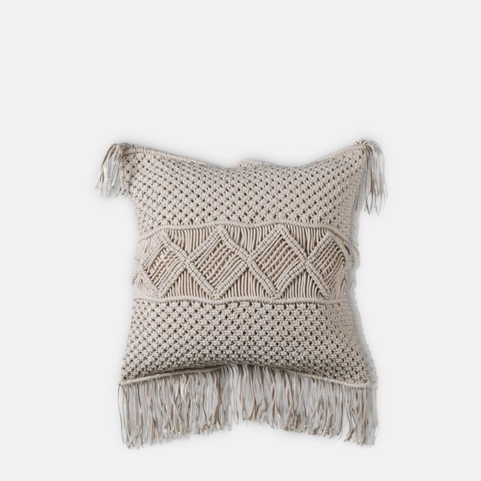 A cutout of the Cassidy Cushion, a square cushion with a cream coloured macrame front and long fringe detail.
