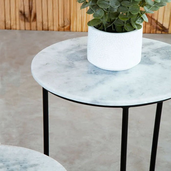 A closeup of the soft white marble top of the Danan Nesting Side Tables.