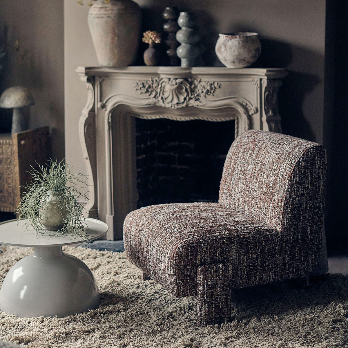 Abigail Ahern Darell Boucle Accent Chair in deep brown textured boucle upholstery, showcasing its softly rounded back, curved arms and generously padded seat in a warm, contemporary living space.