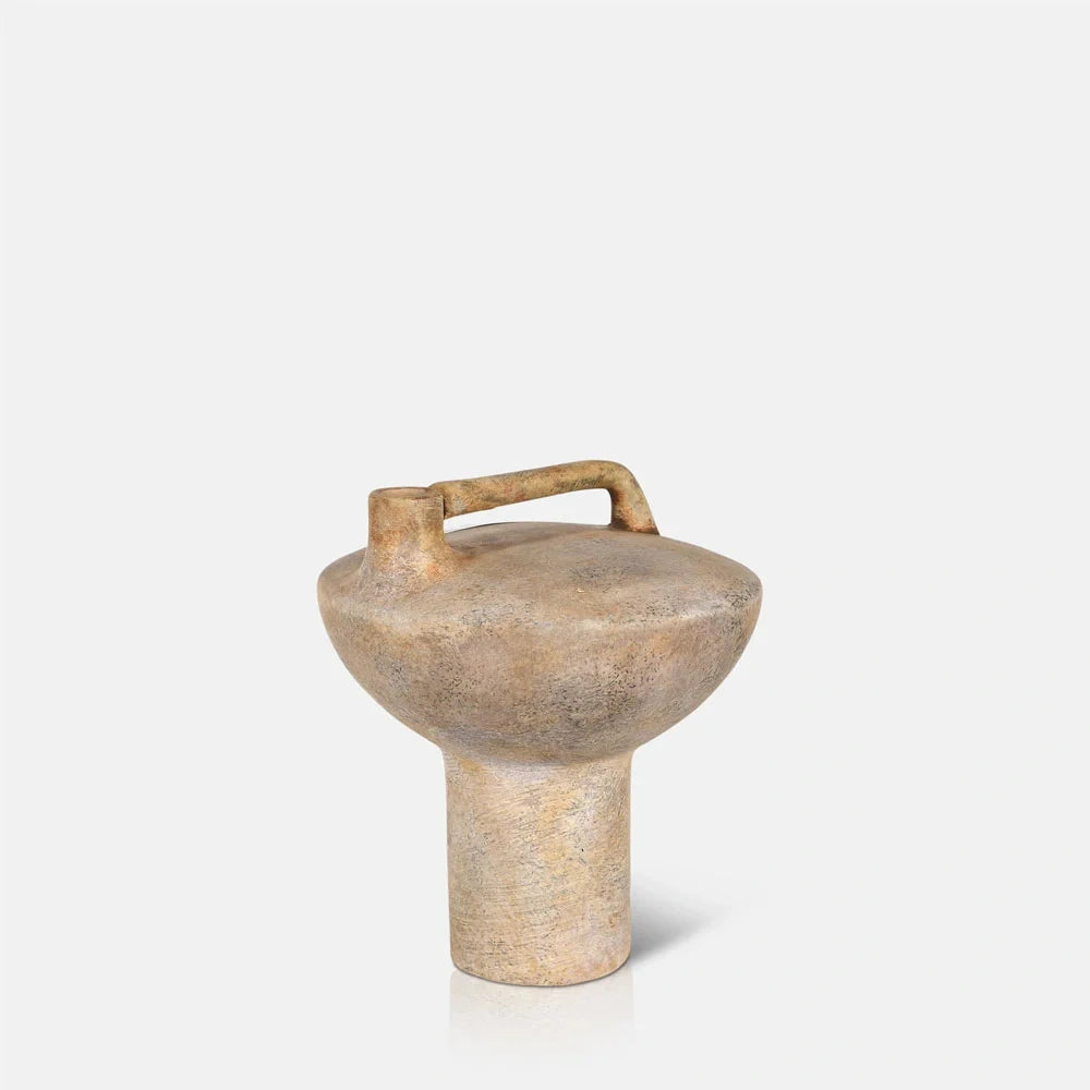 Forbes sand ceramic vase has a textured beige finish, rounded bowl shaped body, cylindrical pedestal and raised rectangular handle extending across the top.