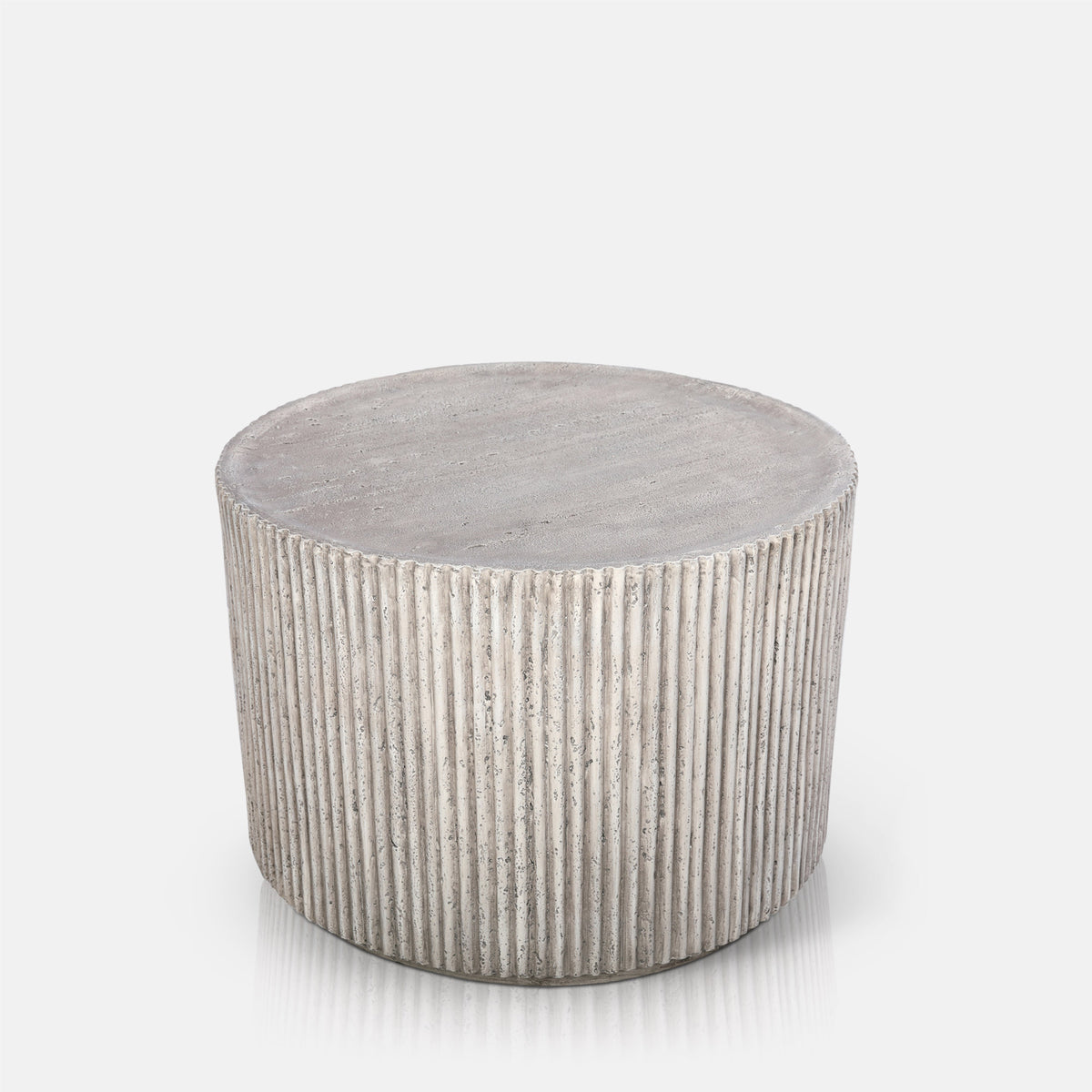 Abigail Ahern Hereford Stone Coffee Table in grey stone-effect finish with a simple round silhouette and textured ribbed detail.