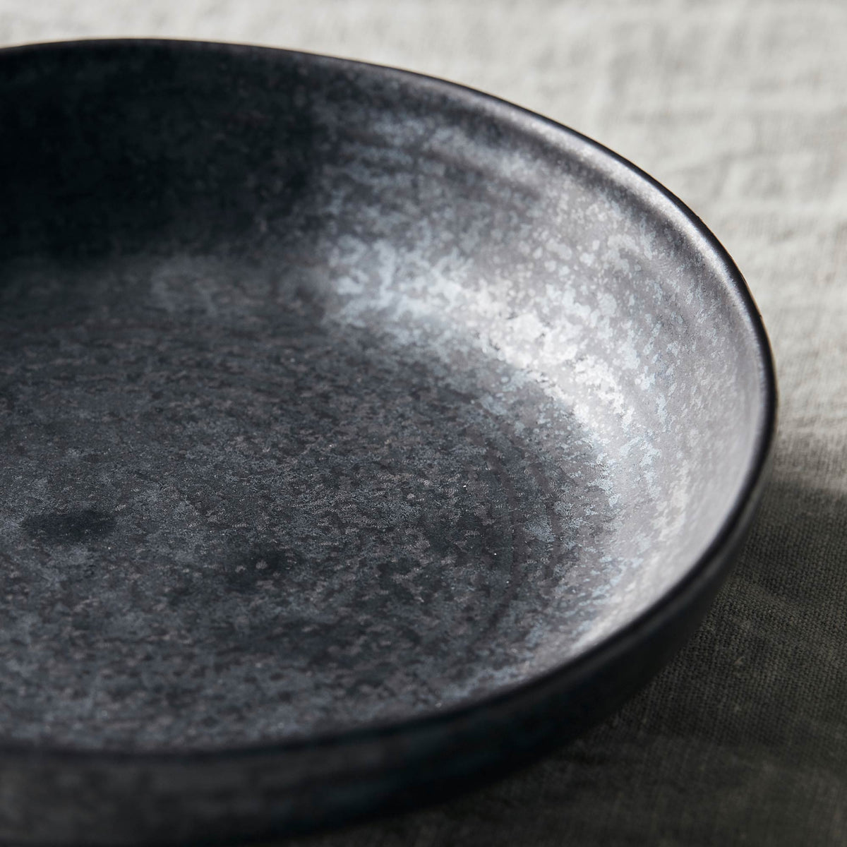 A closeup of the Marple Stoneware Bowl Charcoal showing the speckled effect.