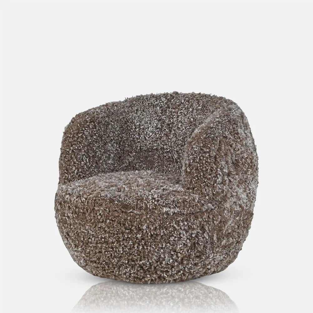 Norwood Sheepskin Swivel Chair has a rounded tub shape with curved arms and a broad cushioned seat, covered in densely textured grey and brown upholstery.
