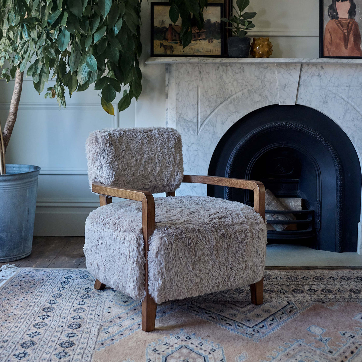 Luxury faux fur armchair featuring a soft textured upholstery, rounded sculptural silhouette, and contemporary organic design with exposed wooden arms complimenting warm neutral tones for modern living spaces.