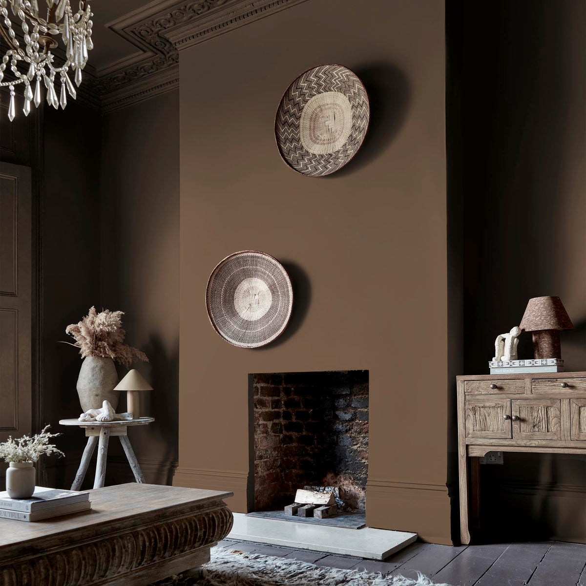Abigail Ahern Owasco Olive paint – a sumptuous rich brown with olive green undertones enveloping a beautifully styled living room fireplace