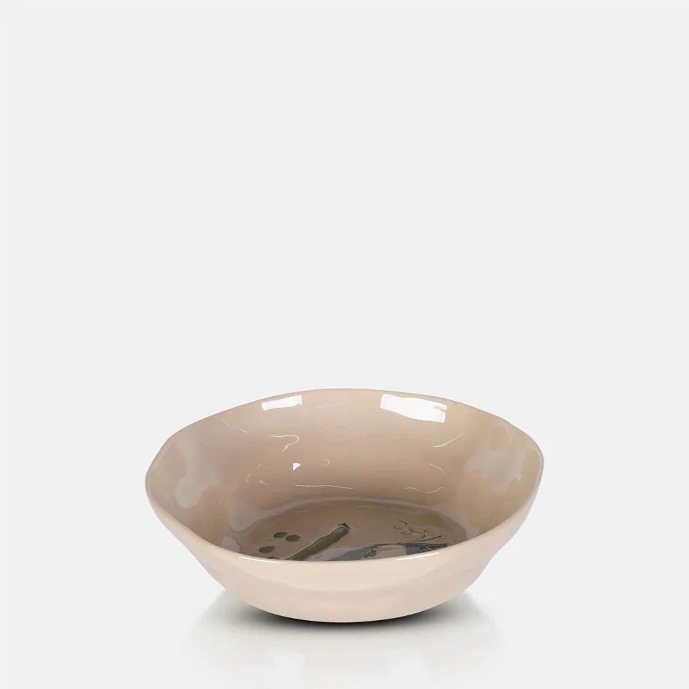 Quincy Ceramic Bowl features a shallow rounded shape with a gently uneven rim, glossy cream glaze and a green pea illustration visible inside.