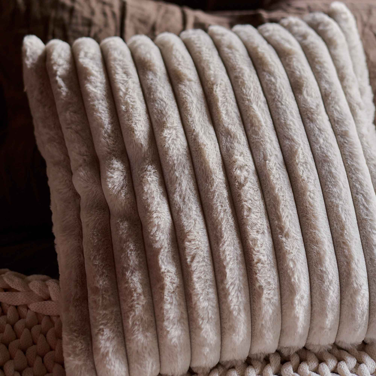 A closeup of the Reva Faux Fur Cushion, showing the rudged stitching detail.