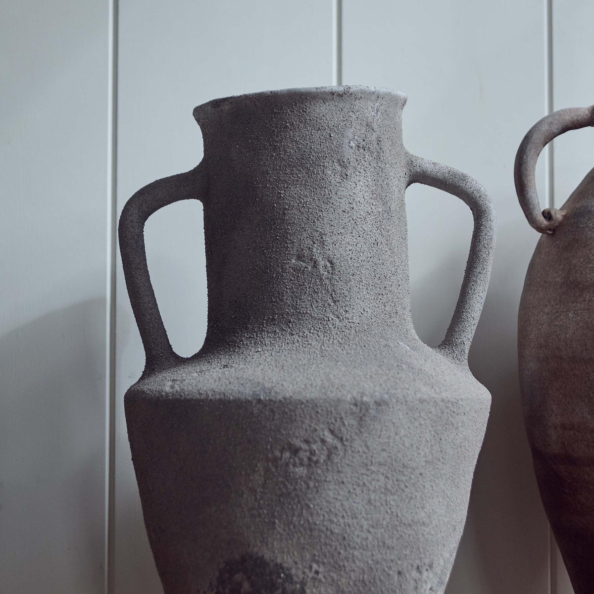 The Rowan Terracotta Vase, an angular grey amphora shaped vase with two handles.
