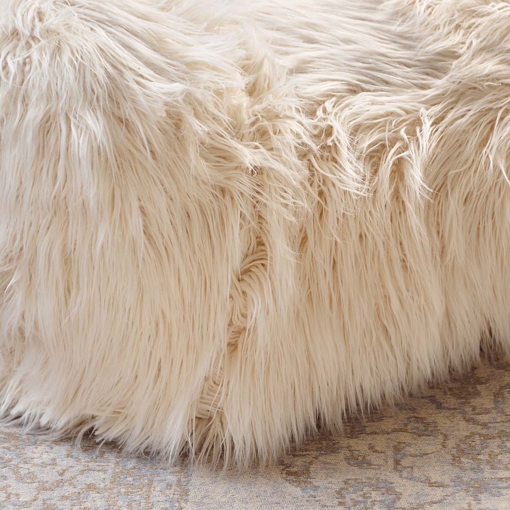 A closeup of the super soft and textural cream coloured shaggy faux fur of the Rowley Faux Fur Armchair.