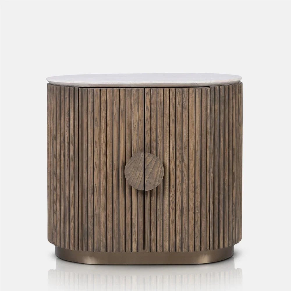 Sheridan wooden cabinet viewed from the front, showing its curved fluted doors, large round handle, pale rounded top and warm wooden tones above a recessed base.