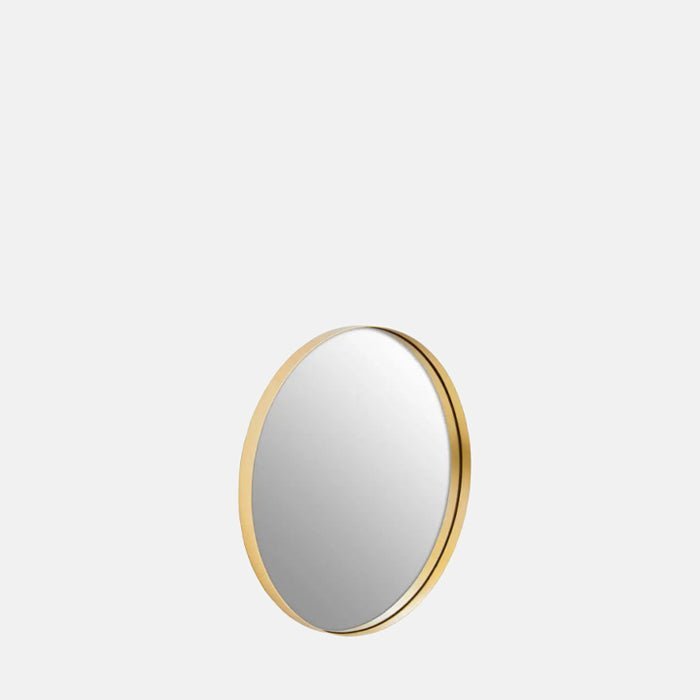 The Small Gold Oakland Mirror, a small round contemporary modern mirror with an ultra-slim gold iron frame.