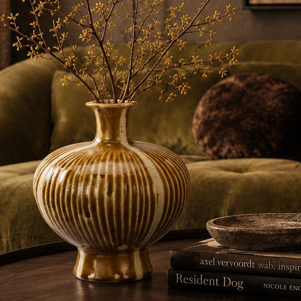 Tallis Stoneware Vase with sculptural ridged form and earthy brown glaze, styled on a pale stone console beside stacked books and softly layered neutral decor.