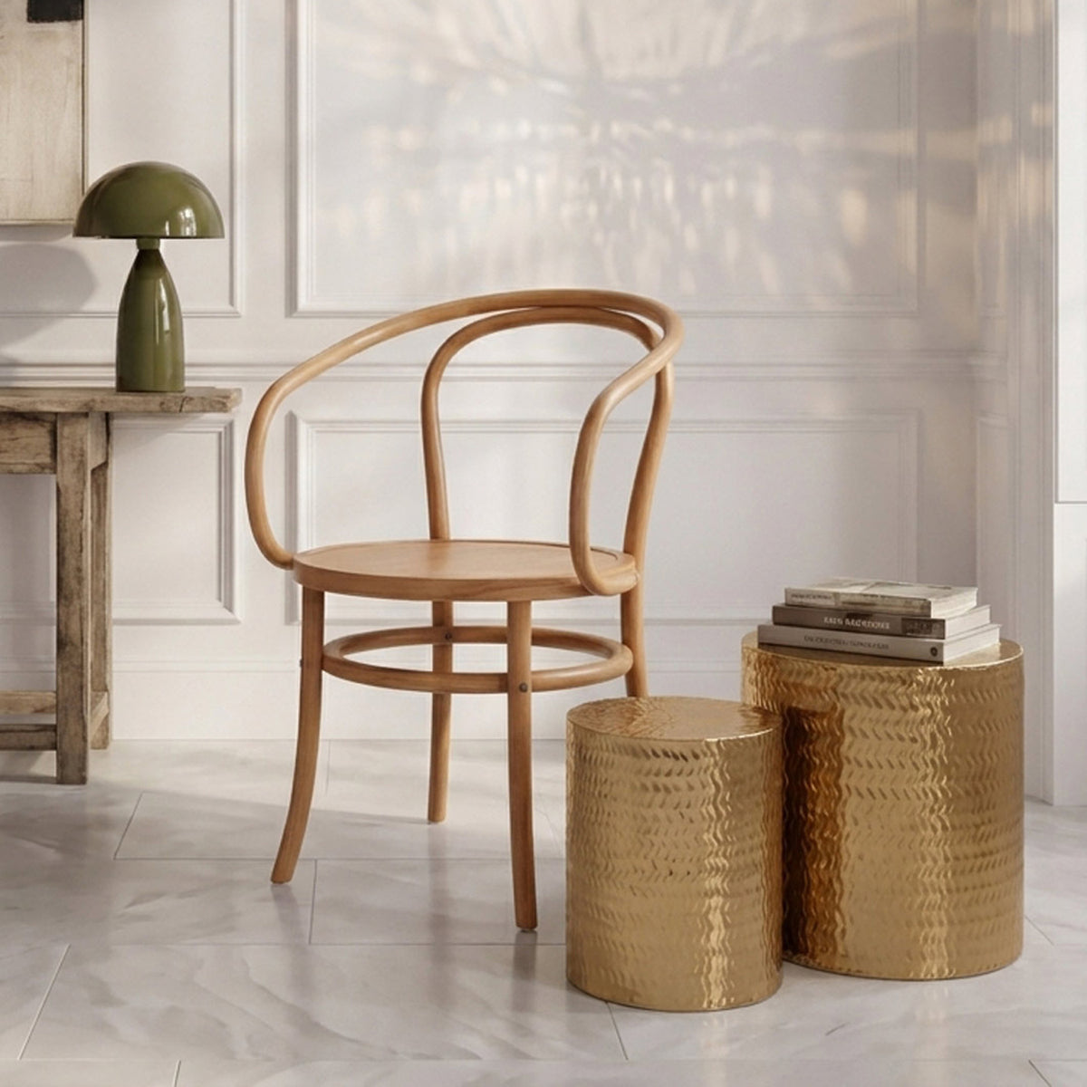 Abigail Ahern Salado Side Tables in metallic gold with etched chevron-patterned surfaces and round sculptural silhouettes, styled together as statement tables in a contemporary living room.