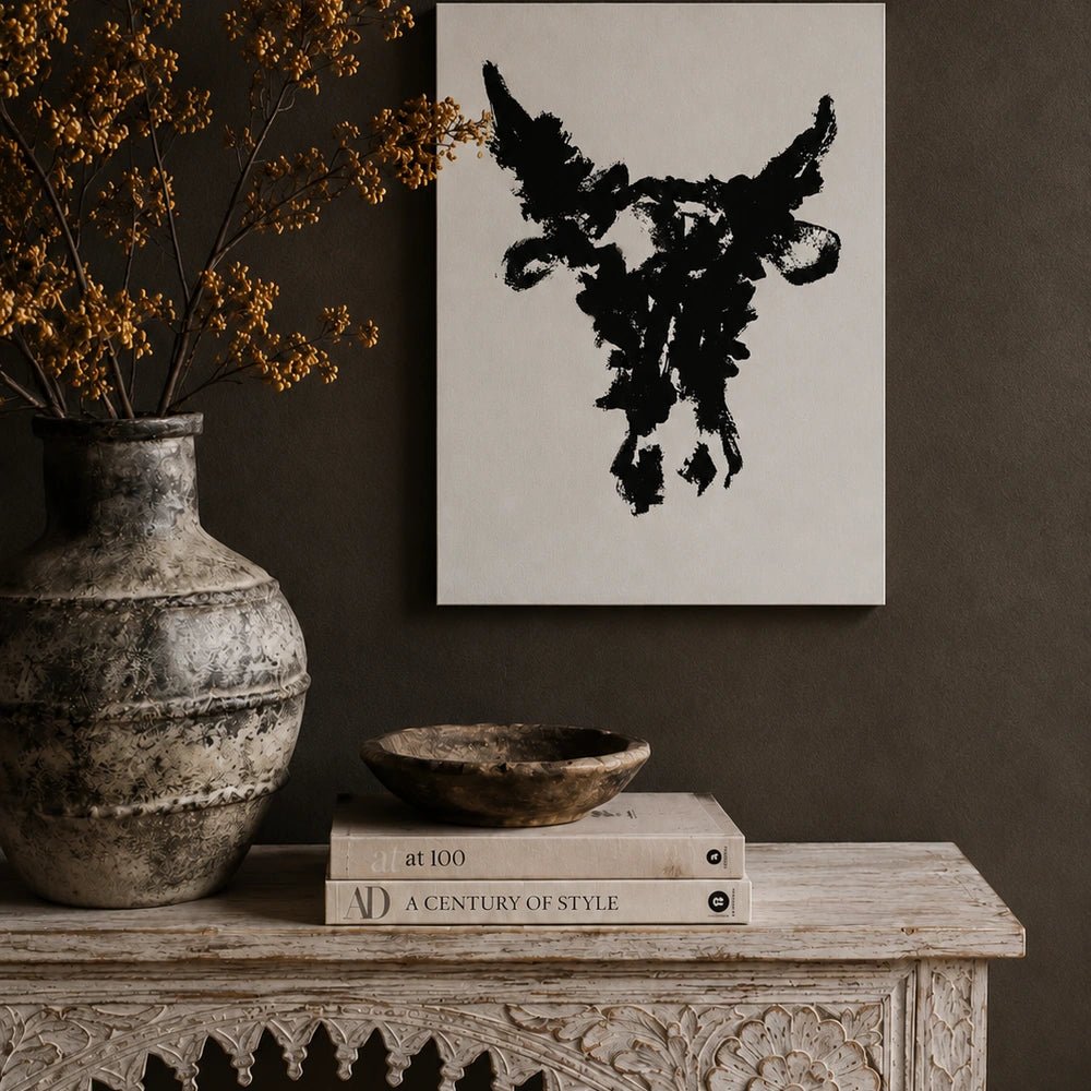 Taurus monochrome bull artwork shown in a close framed view, with expressive black brush marks on a pale background and warm neutral wall styling.