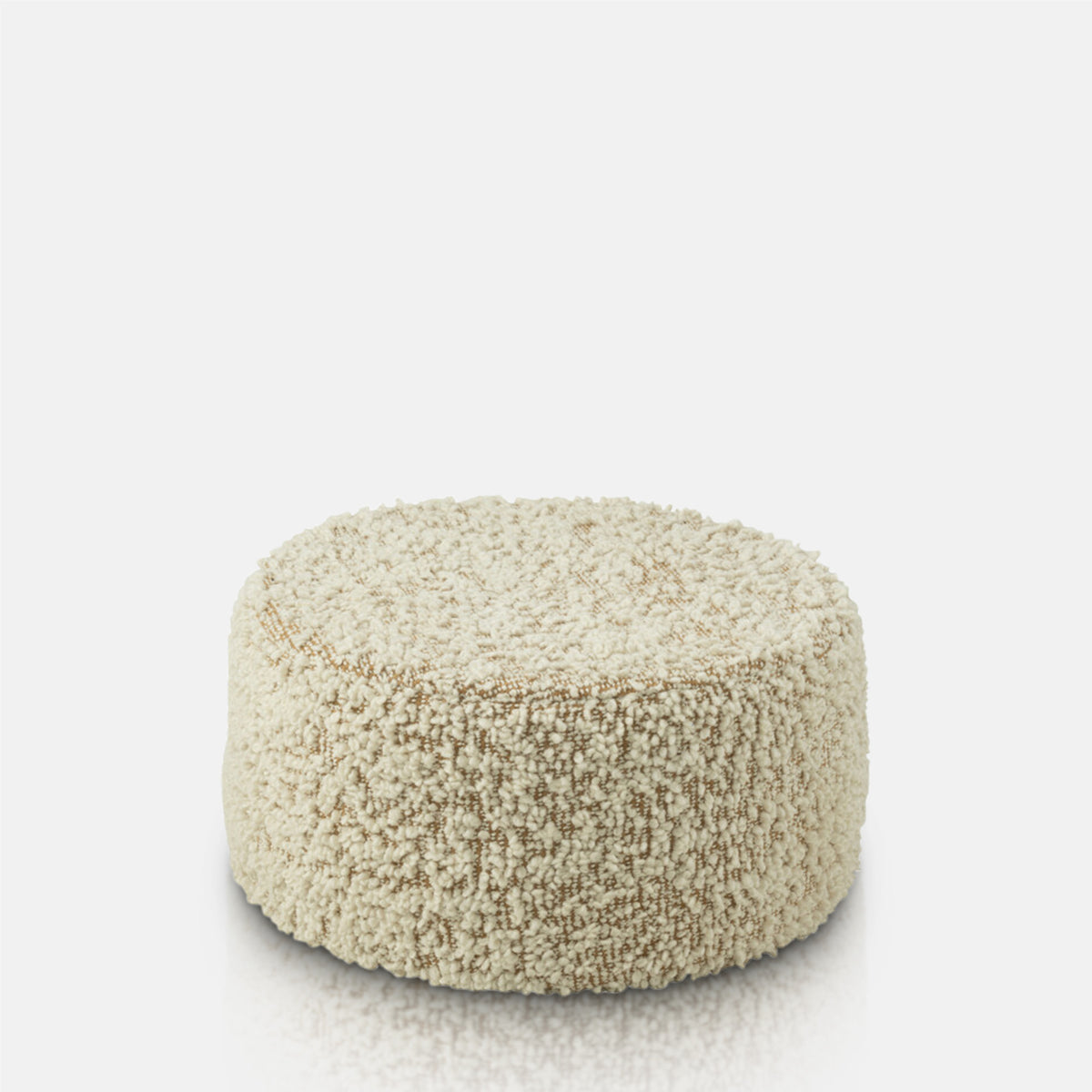 A cutout of the Walker Boucle Pouffe, a circular pouffe in warm brown with cream boucle accents.