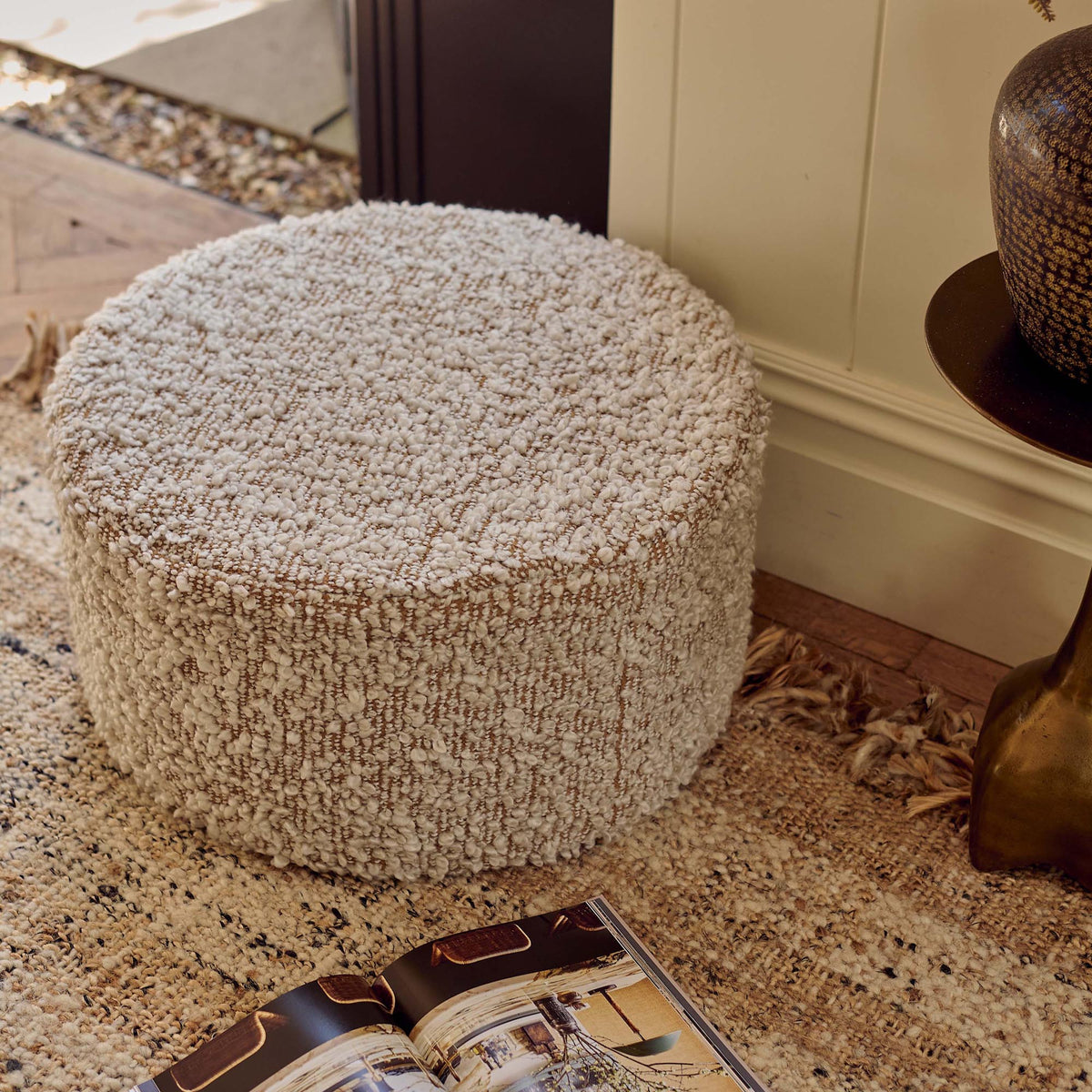 A top view of the Walker Boucle Pouffe, a circular pouffe in warm brown with cream boucle accents.
