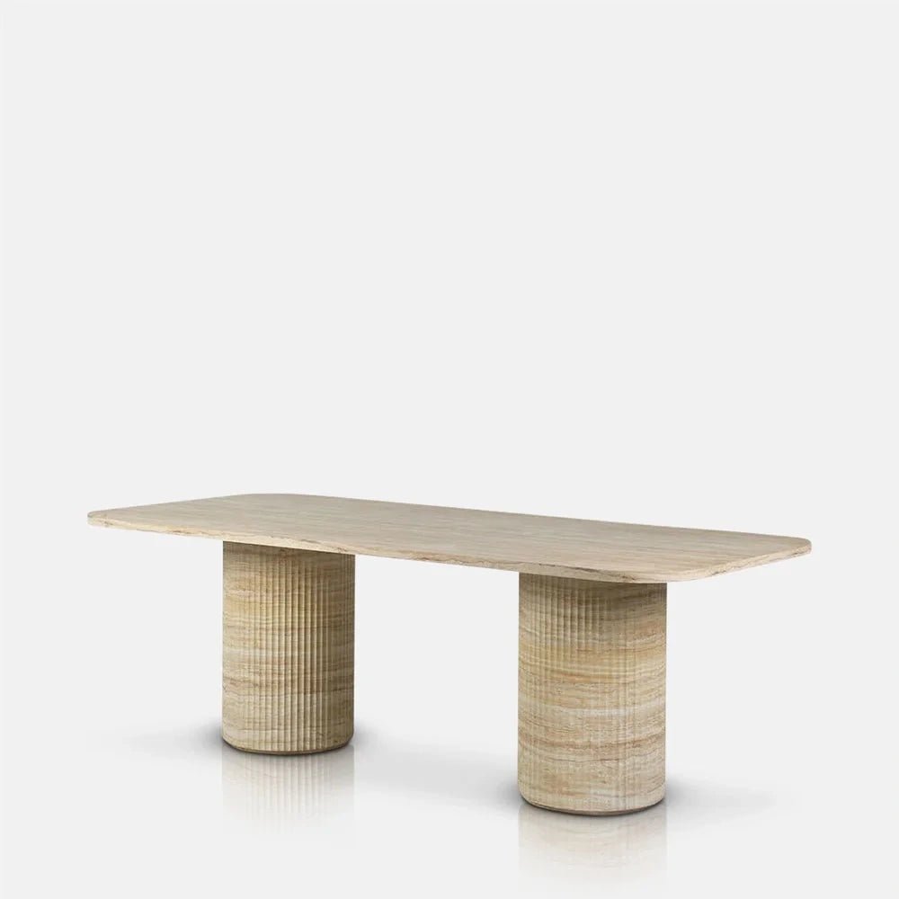 Westwood faux travertine dining table viewed at an angle, showing its pale rounded rectangular top and twin cylindrical bases with horizontal cream and beige patterning.