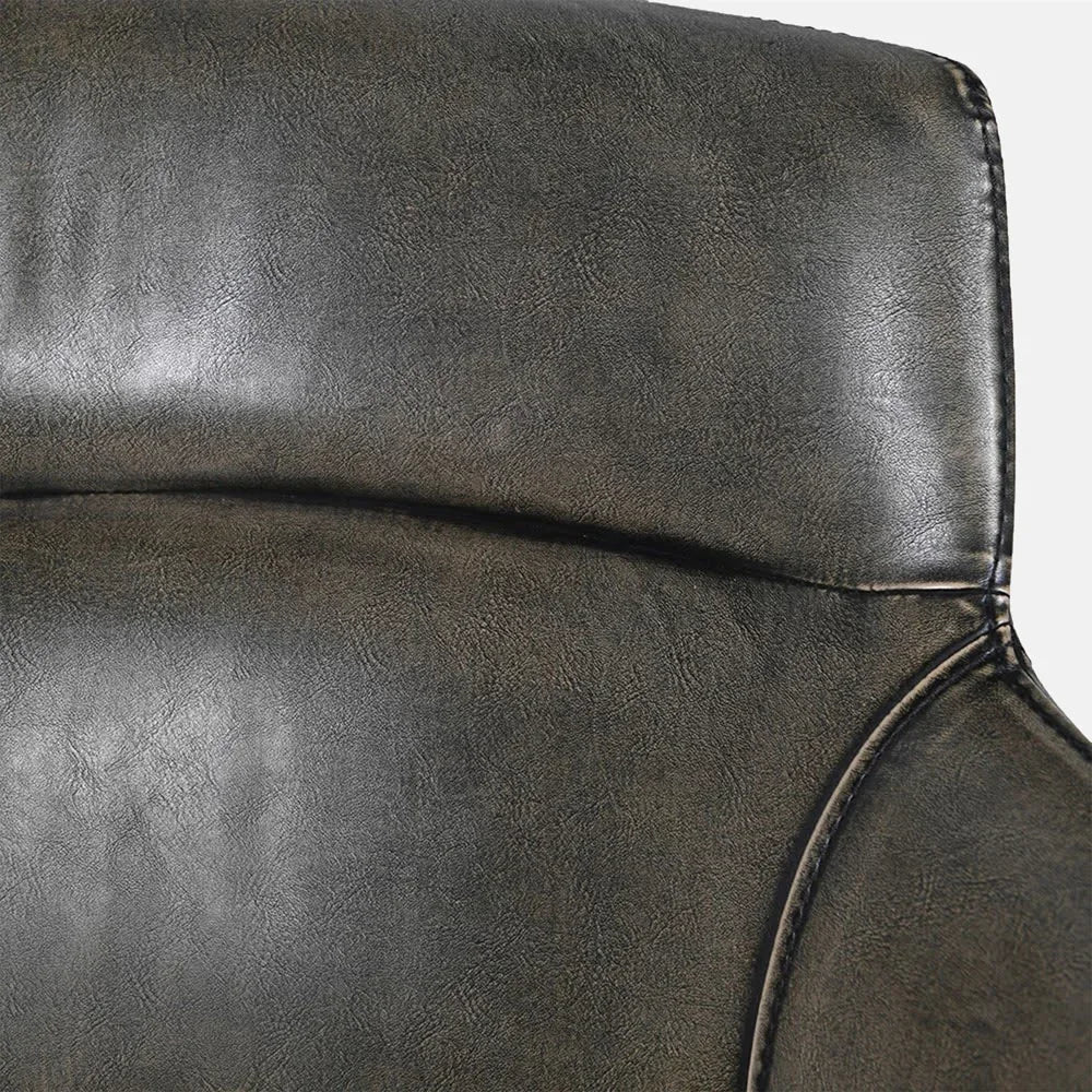 Whitcomb faux leather dining chair backrest shown close up, revealing dark textured upholstery, subtle creasing, stitched edges and horizontal padding above the curved side support.