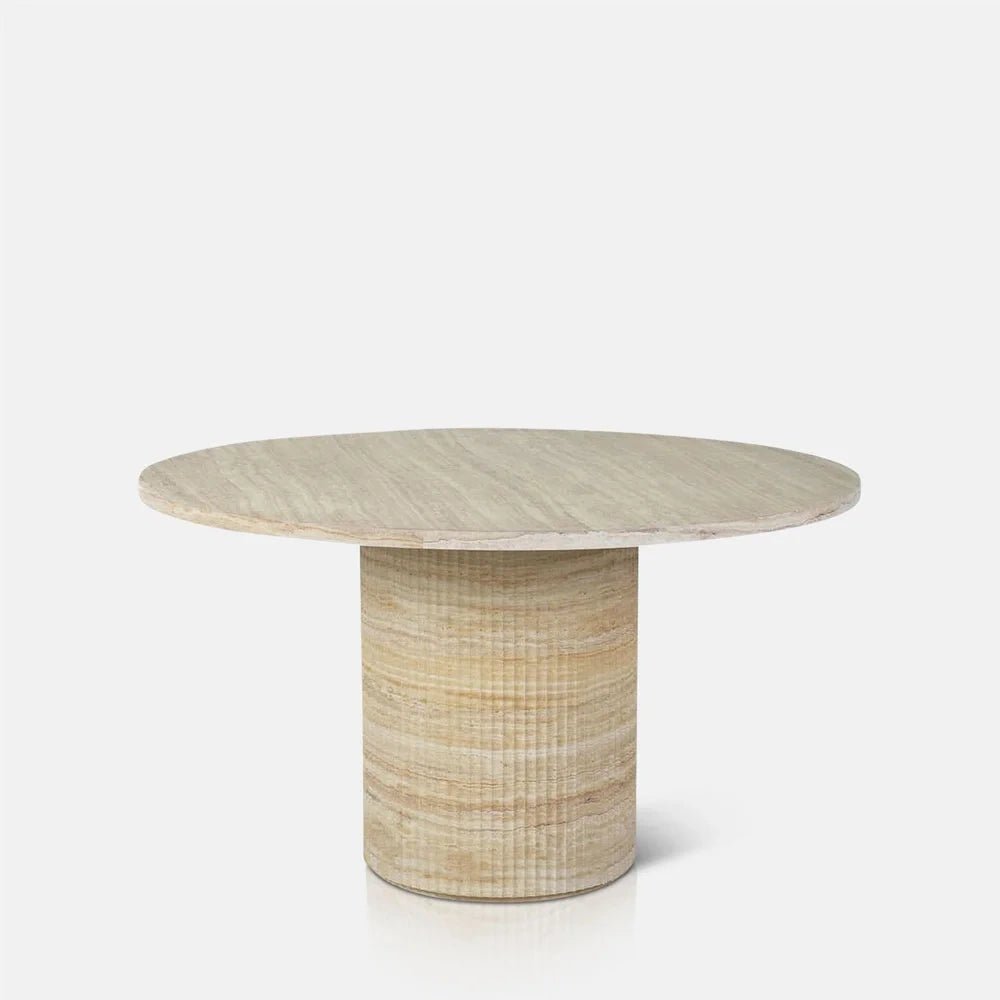 Wilcox faux travertine dining table with a pale circular top and wide cylindrical pedestal features softly rounded edges and horizontal cream and beige patterning.