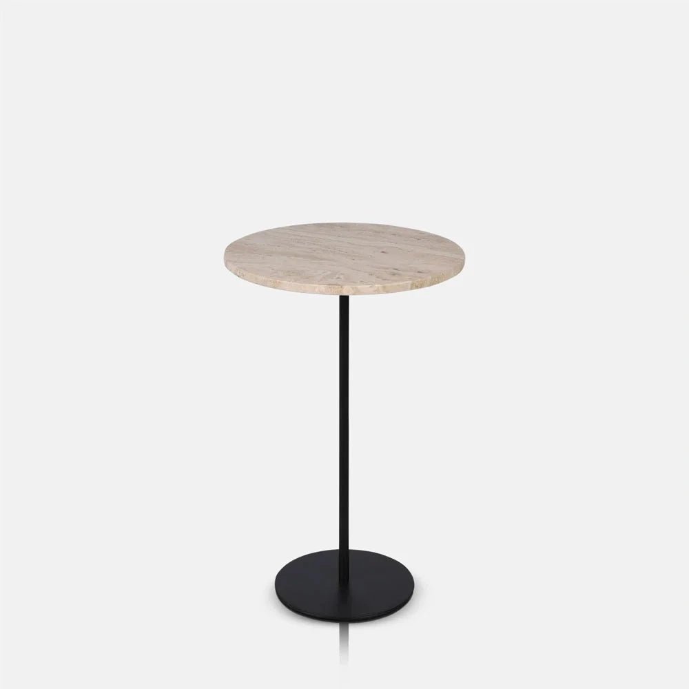 Winthrop travertine side table with a pale circular stone top, slender black central stem and flat round black base has a compact, minimal profile.