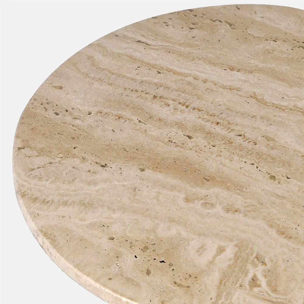 Winthrop travertine side table shown close up, highlighting the pale cream and beige stone top, rounded edge, natural pits and softly layered diagonal veining.